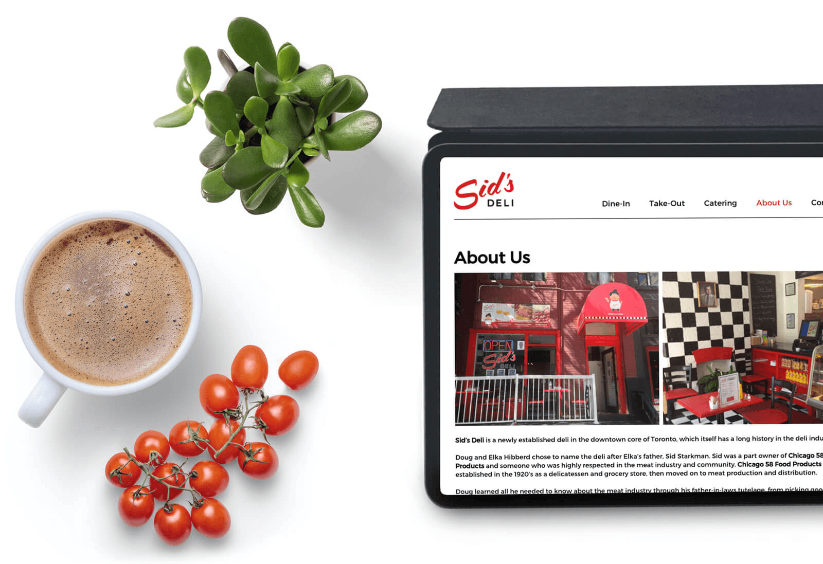 Top view of a desk with Sid's website open on an iPad