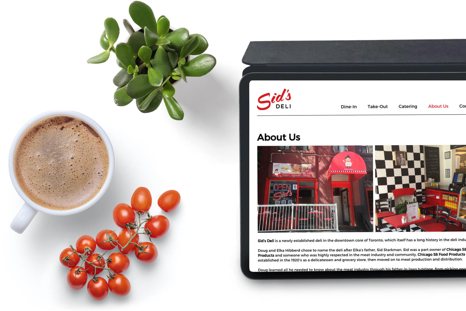Top view of a desk with Sid's website open on an ipad