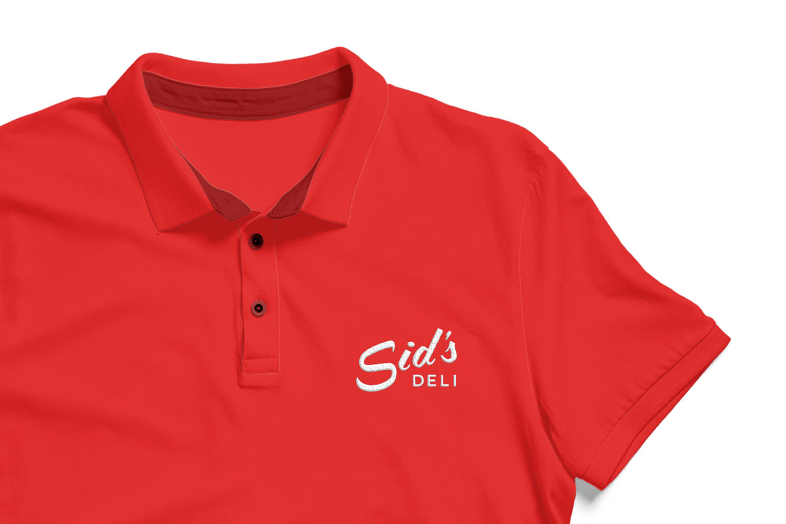 A branded service shirt with Sid's Deli embroidered