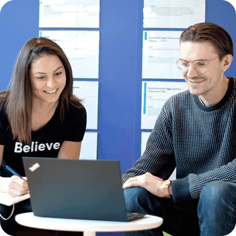 Two people working at a laptop together