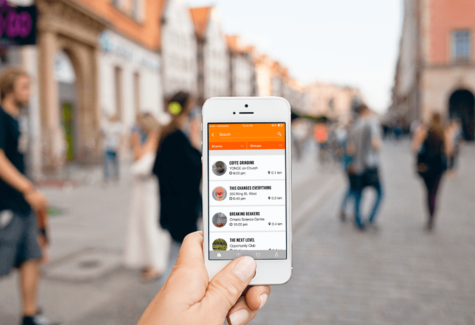 A hand holding a phone with the WhatNow app open in a street